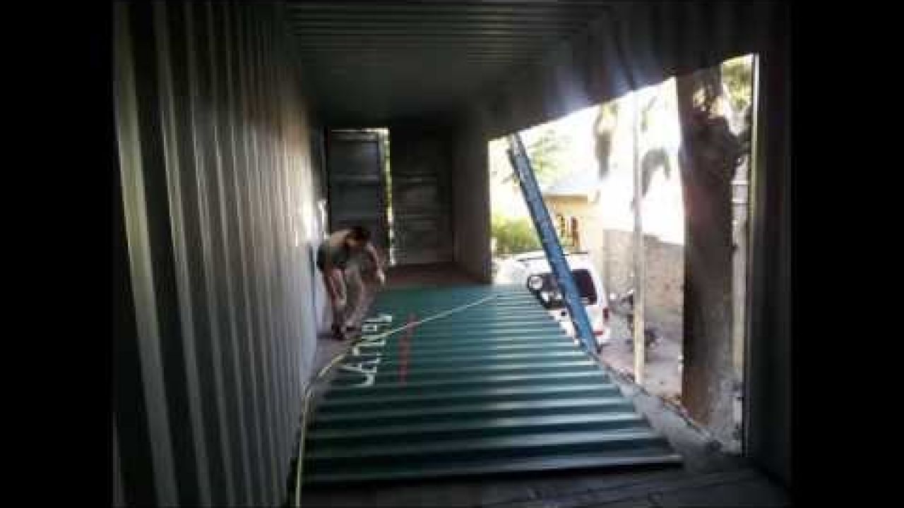 Cutting windows in a shipping container home.